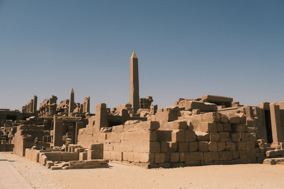 Explore the historic Karnak Temple complex in Luxor, showcasing ancient architecture under a clear sky.
