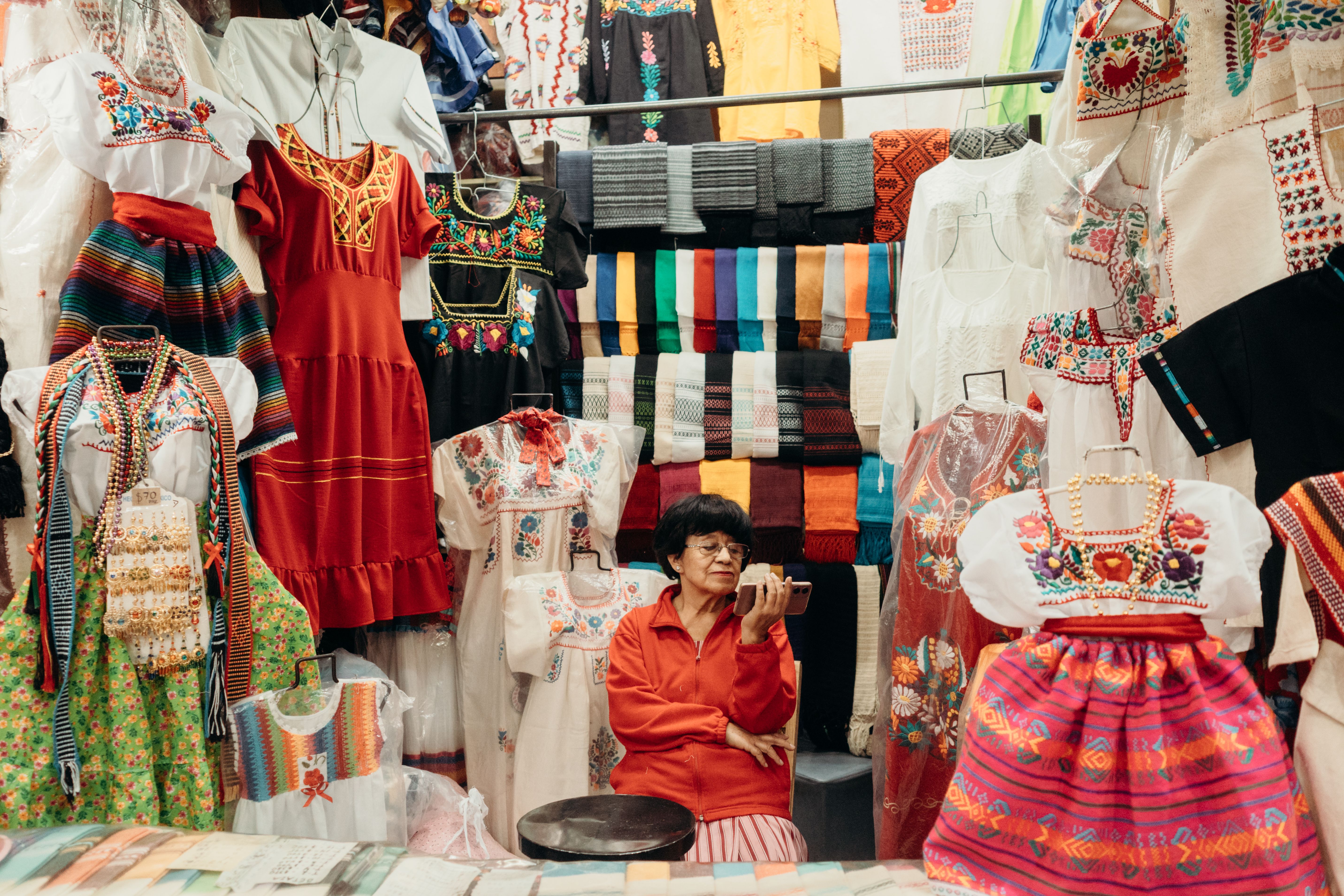 Vibrant market stall displaying traditional Mexican crafts like Talavera pottery and alebrijes