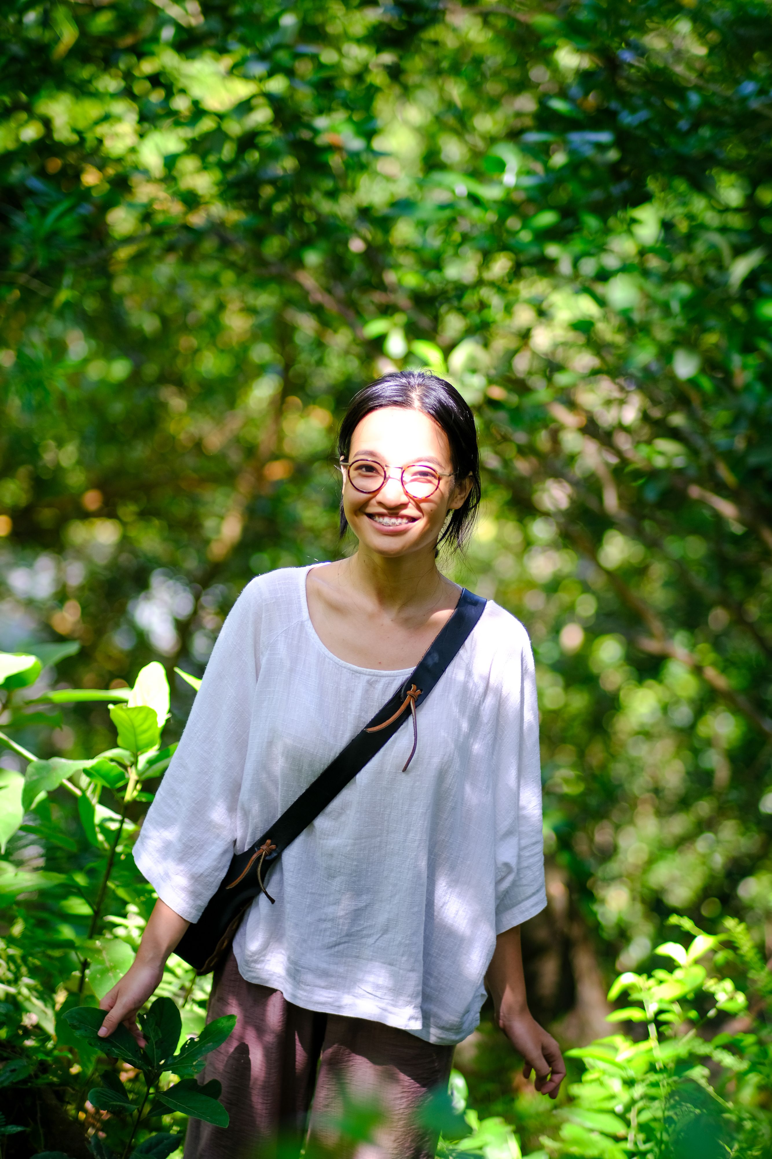 Smiling Woman in Lush Vietnamese Forest · Free Stock Photo