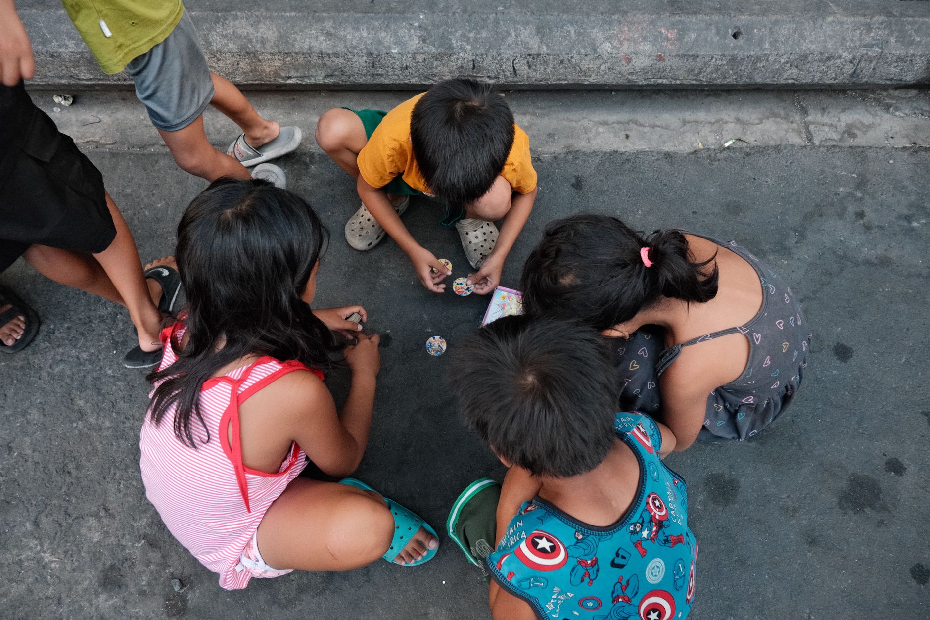 A group of children playing a traditional game on streets of Philippines.