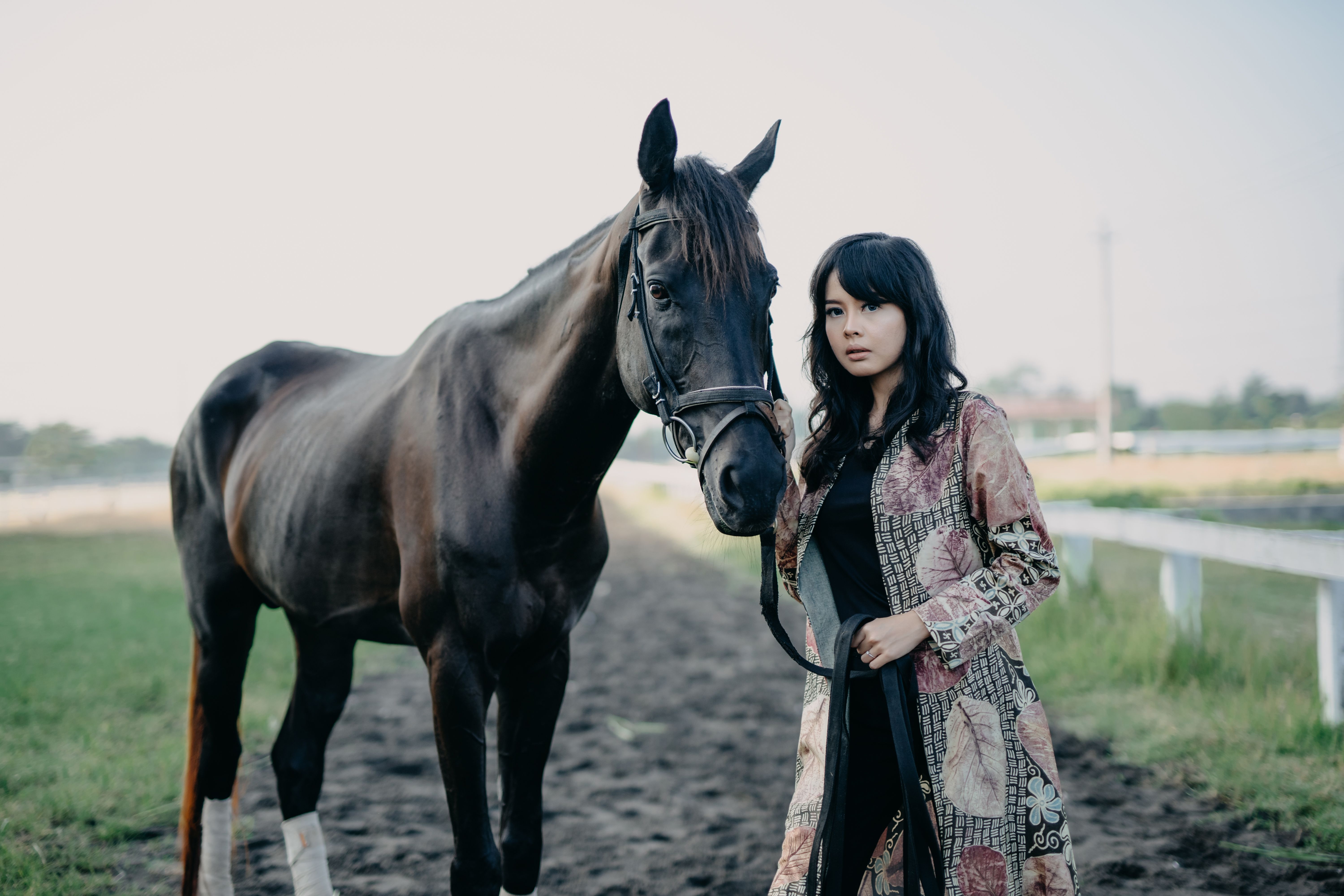 Young Woman with Horse on Rural Path in Indonesia