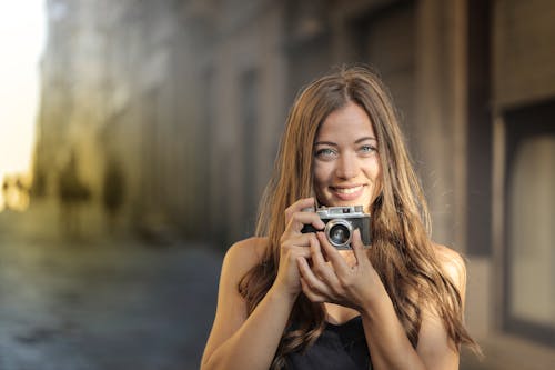 Woman Holding Digital Camera 