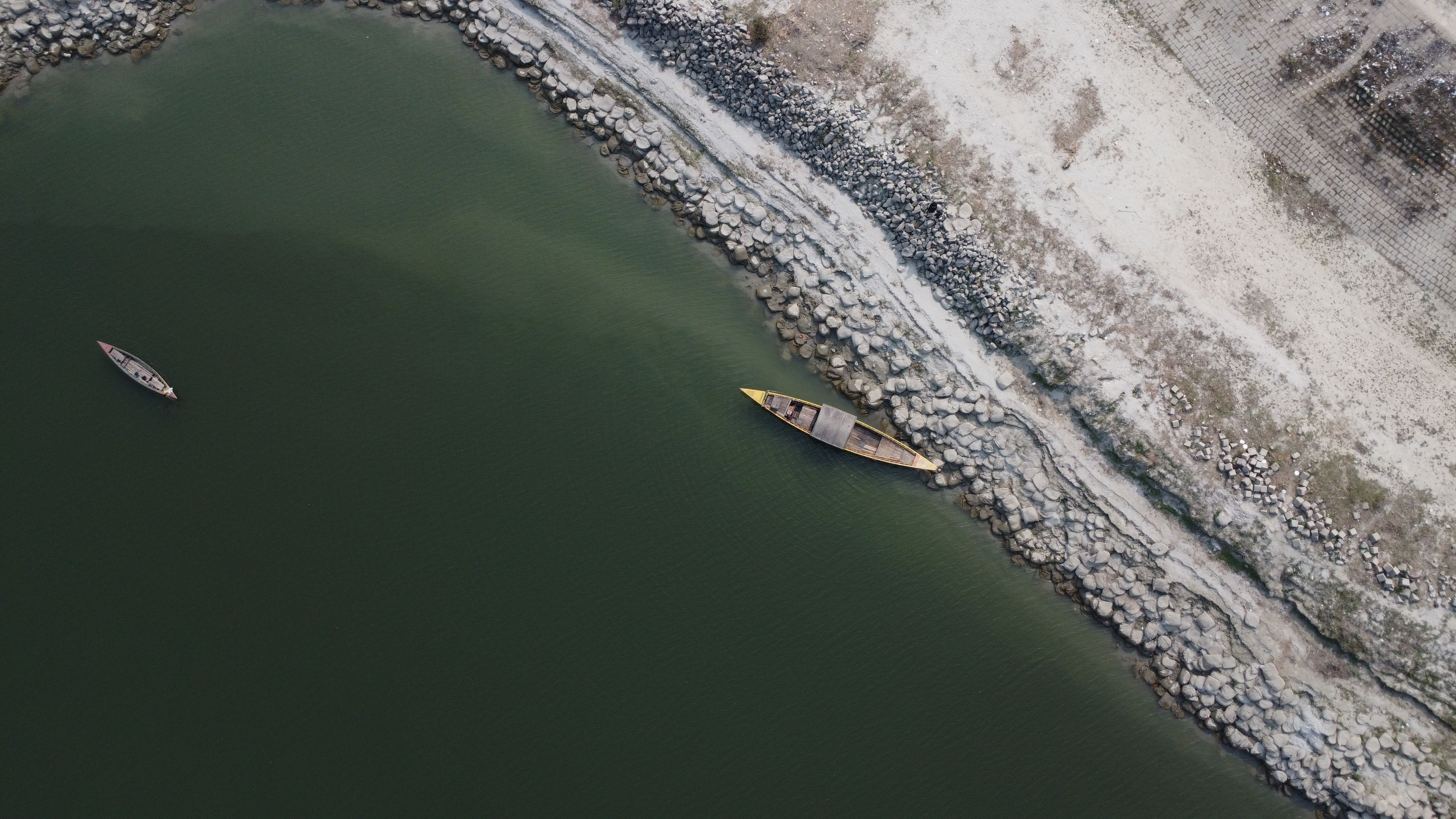 Aerial View of Boats on Serene Riverbank · Free Stock Photo
