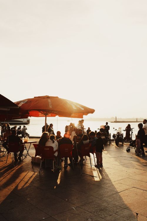 Free People enjoying sunset at an outdoor cafe by the Bosphorus in İstanbul, Türkiye. Stock Photo