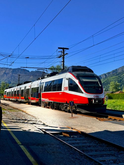 Free ÖBB train in the scenic landscape of Hallstatt, capturing Austrian railway charm. Stock Photo