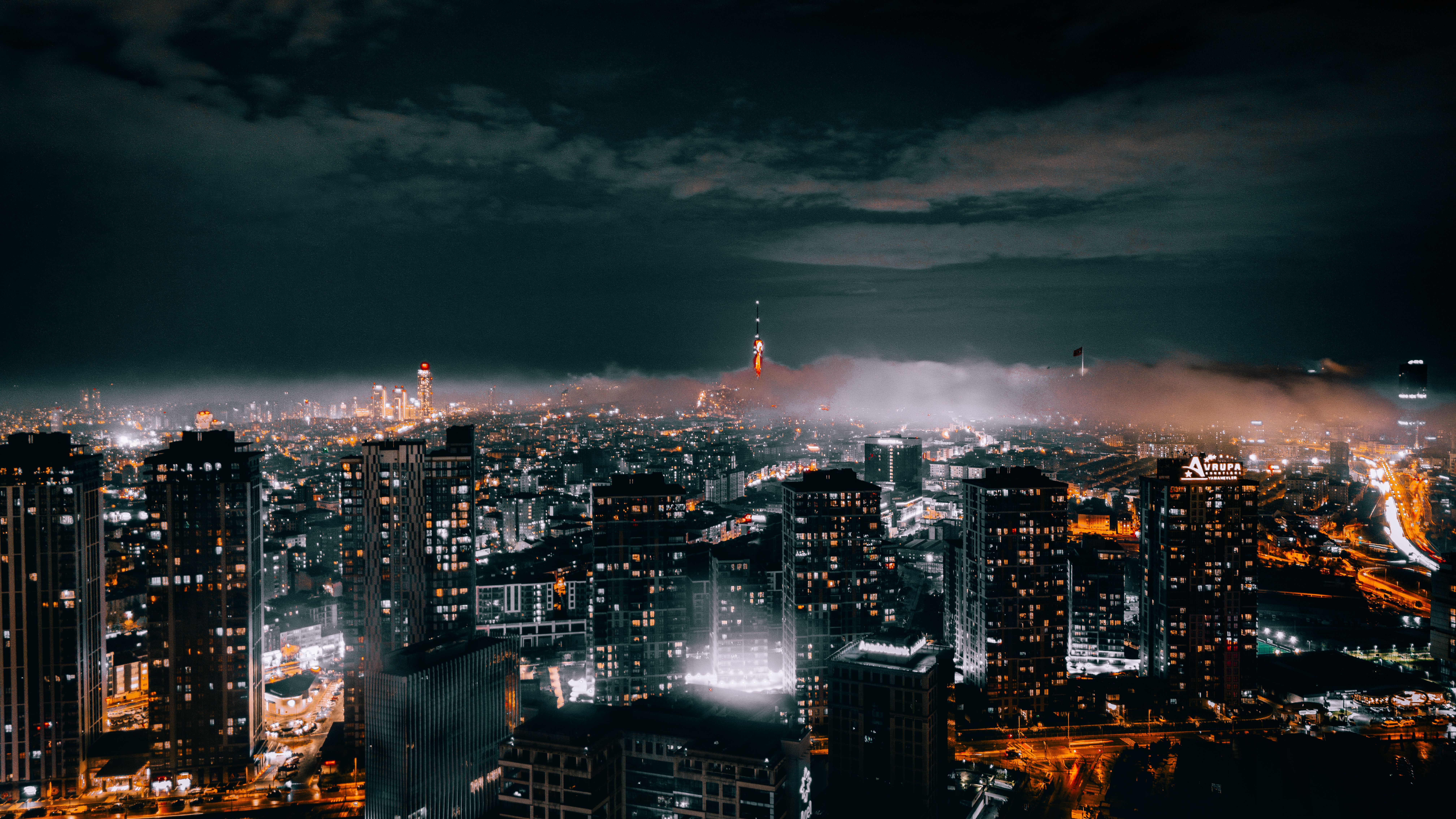Breathtaking night view of İstanbul's illuminated skyline, showcasing modern architecture and vibrant city lights.