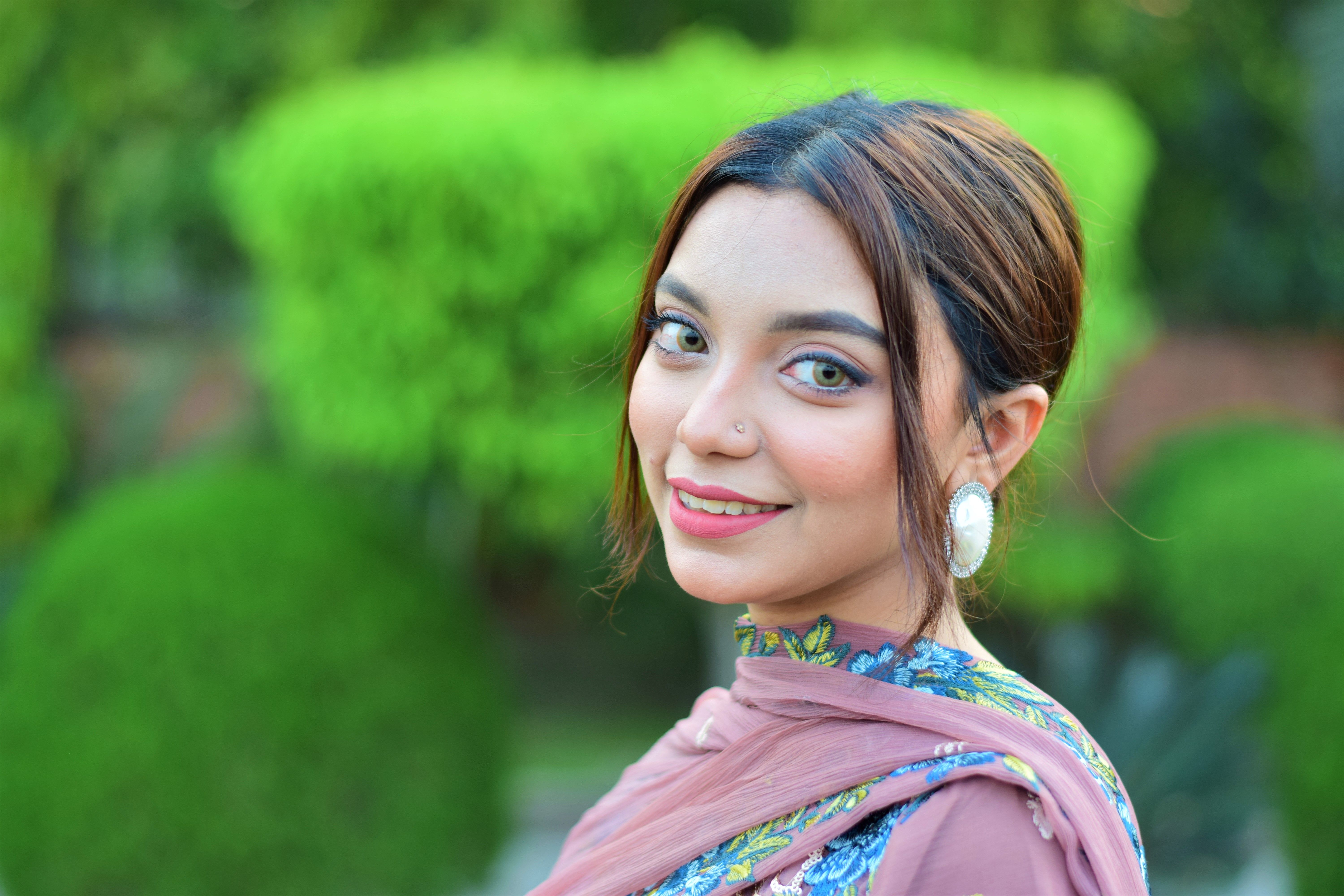 A stunning portrait of a young woman in traditional Bangladeshi attire, exuding grace and elegance.