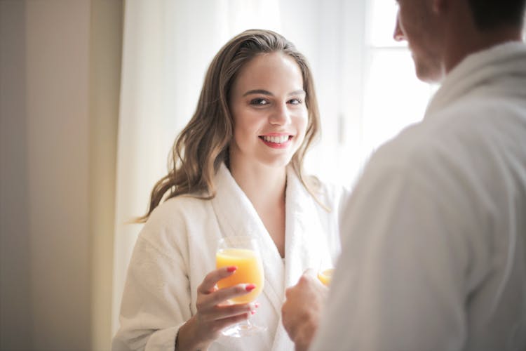 Smiling Woman With Glass Of Fresh Juice At Home