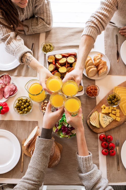 Free People Holding Drinking Glass With Orange Juice Stock Photo