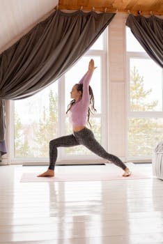 Woman practicing yoga in a sunlit Scandinavian-style room, embodying peace and balance.