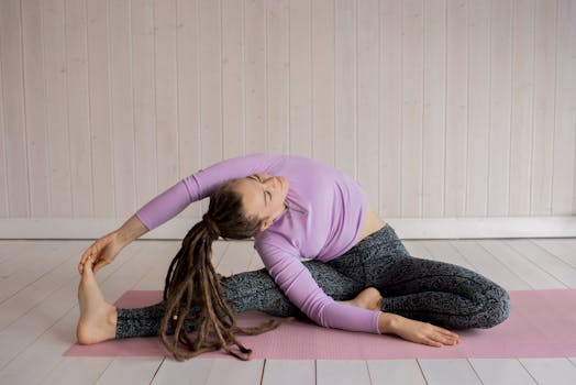 Woman in yoga pose stretching indoors on a mat, promoting wellness and flexibility.