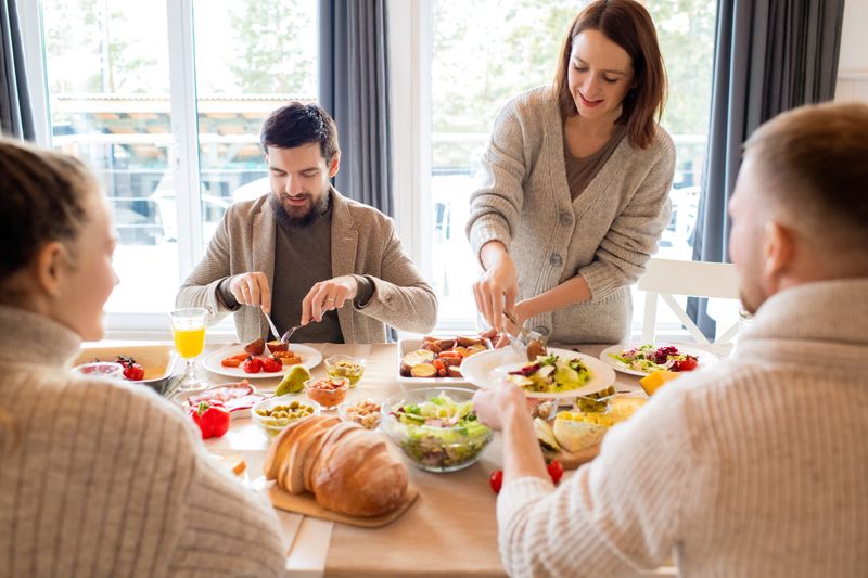 Four friends sharing a delightful meal indoors, highlighting friendship and togetherness.