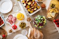 A vibrant table setting with a variety of fresh and delicious foods perfect for a festive gathering.