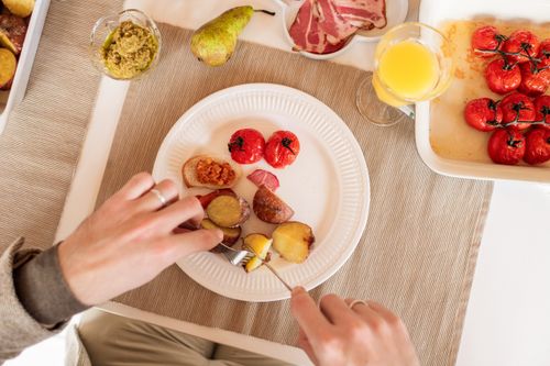 Free Top view of a delicious homemade breakfast with roasted tomatoes, potatoes, and juice. Stock Photo