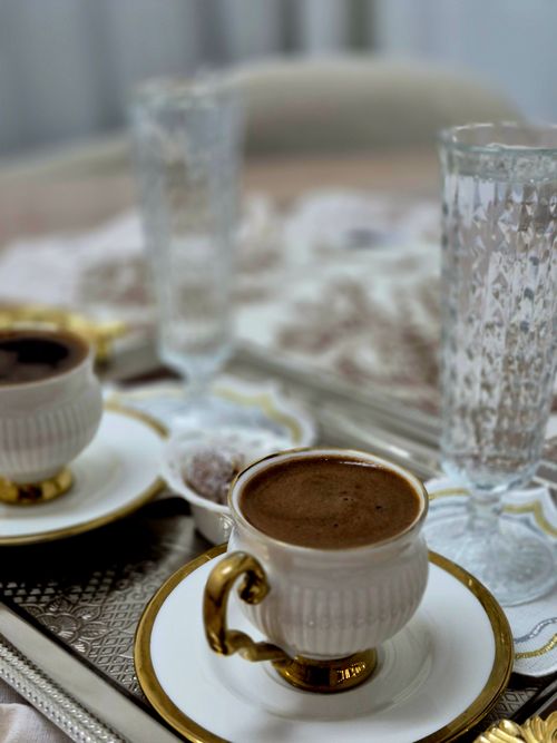 Free Rich Turkish coffee served in ornate cups, paired with vintage crystal glasses on a decorative tray. Stock Photo