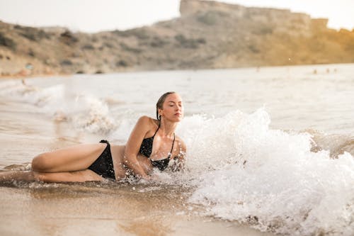 Frau Im Schwarzen Bikini, Der Am Strand Liegt