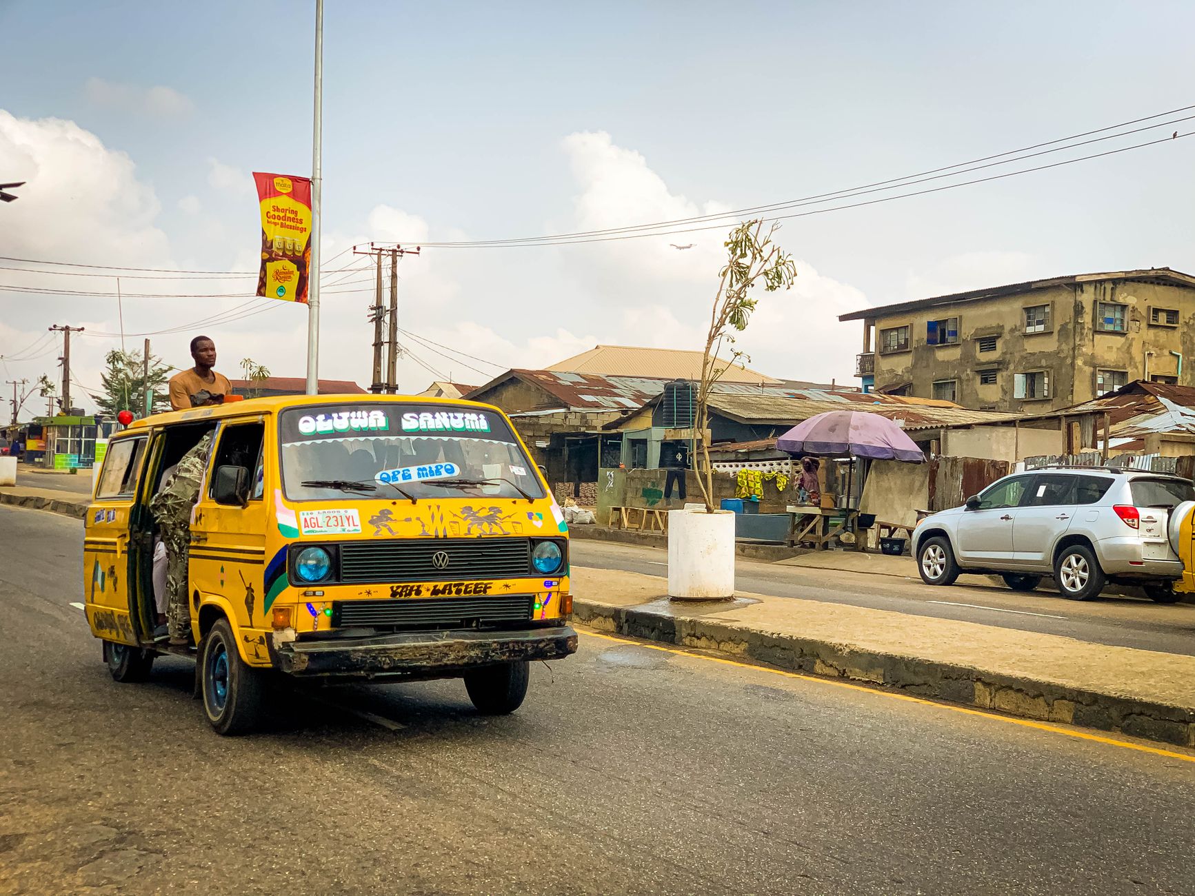 Yellow danfo bus travelling on a road in Lagos, Nigeria