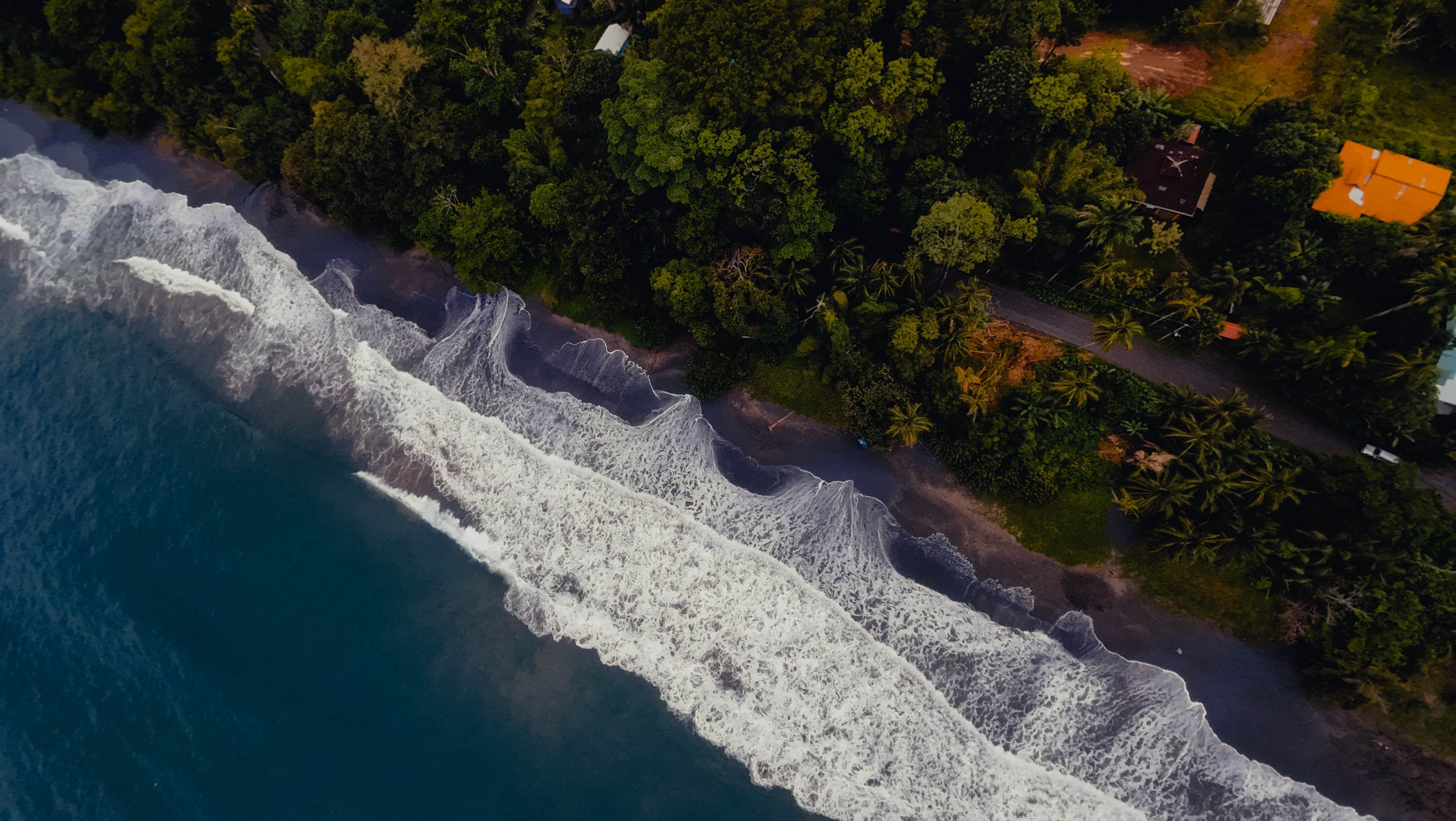 Aerial view of the Puerto Viejo de Talamanca coastline with rainforest meeting the ocean