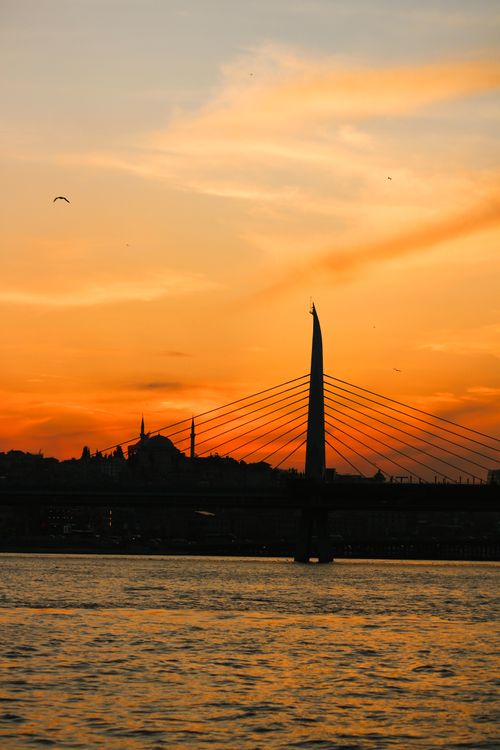 Free A stunning sunset over Istanbul with a bridge silhouette against vibrant skies. Stock Photo