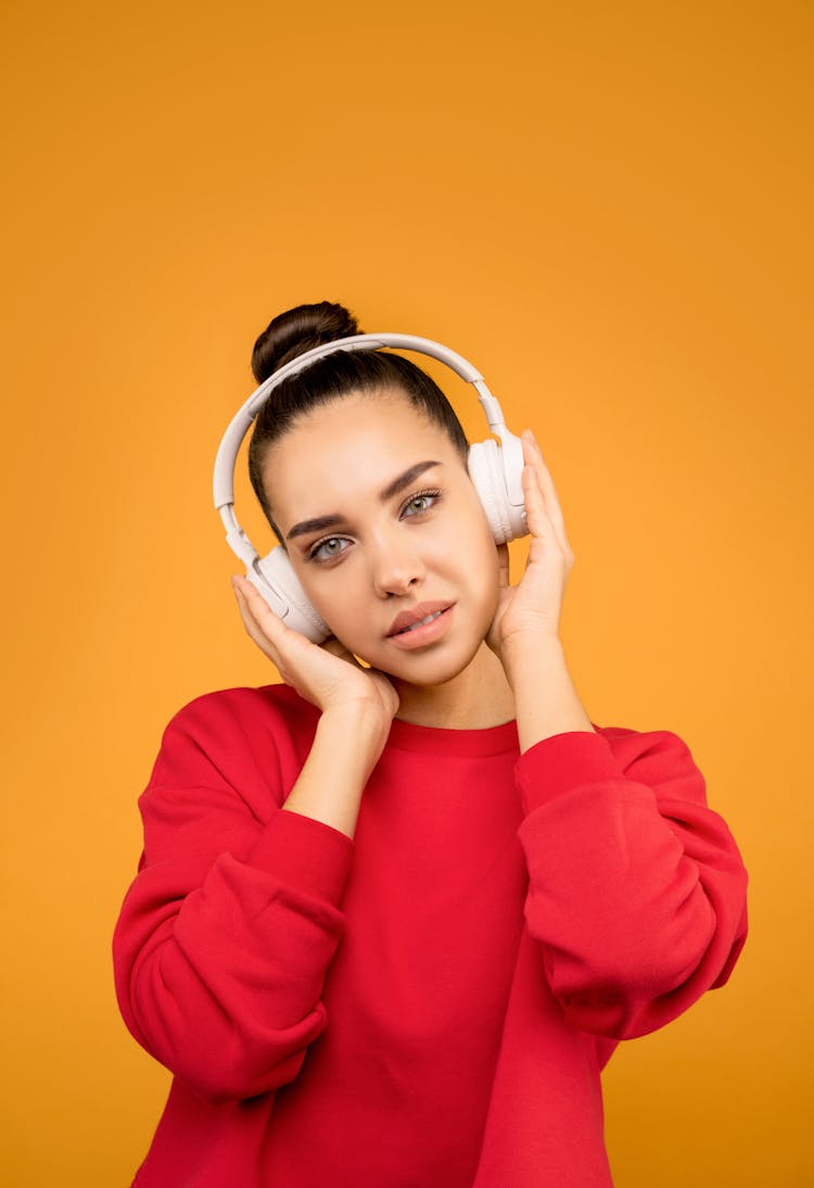 Young Woman Wearing Red Long Sleeves And White Headphones