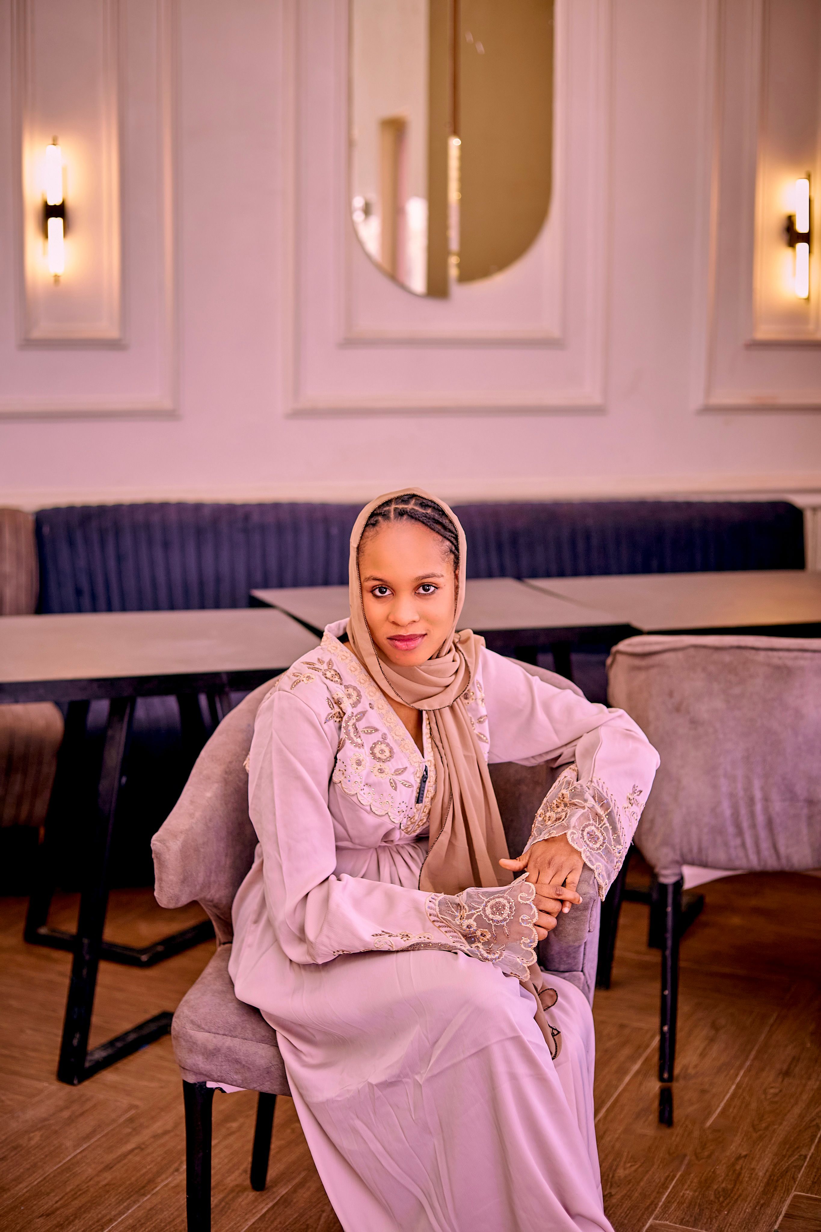 Elegant Woman in Traditional Attire Seated Indoors · Free Stock Photo