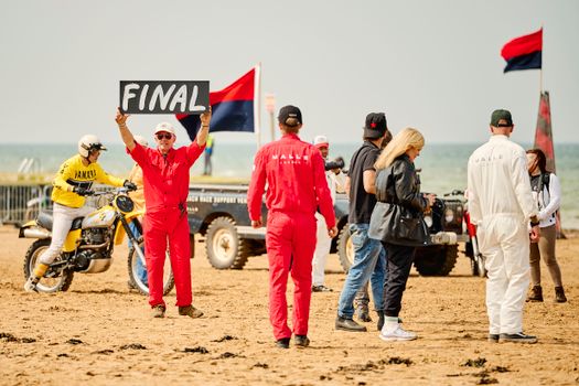 Exciting motorcycle beach race finale in Margate, showcasing colorful racers and lively spectators.