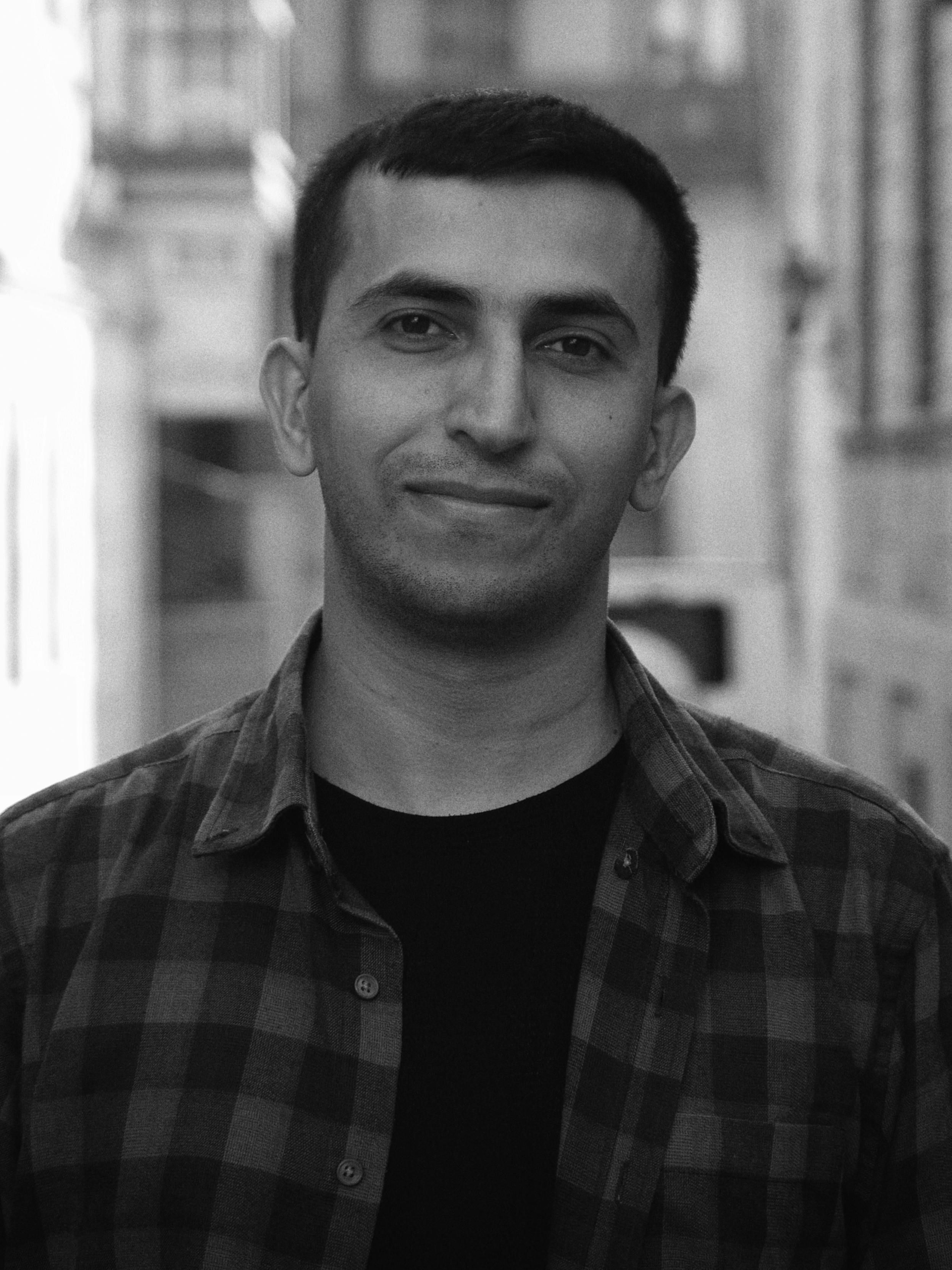 Black and white portrait of a young man in urban environment.