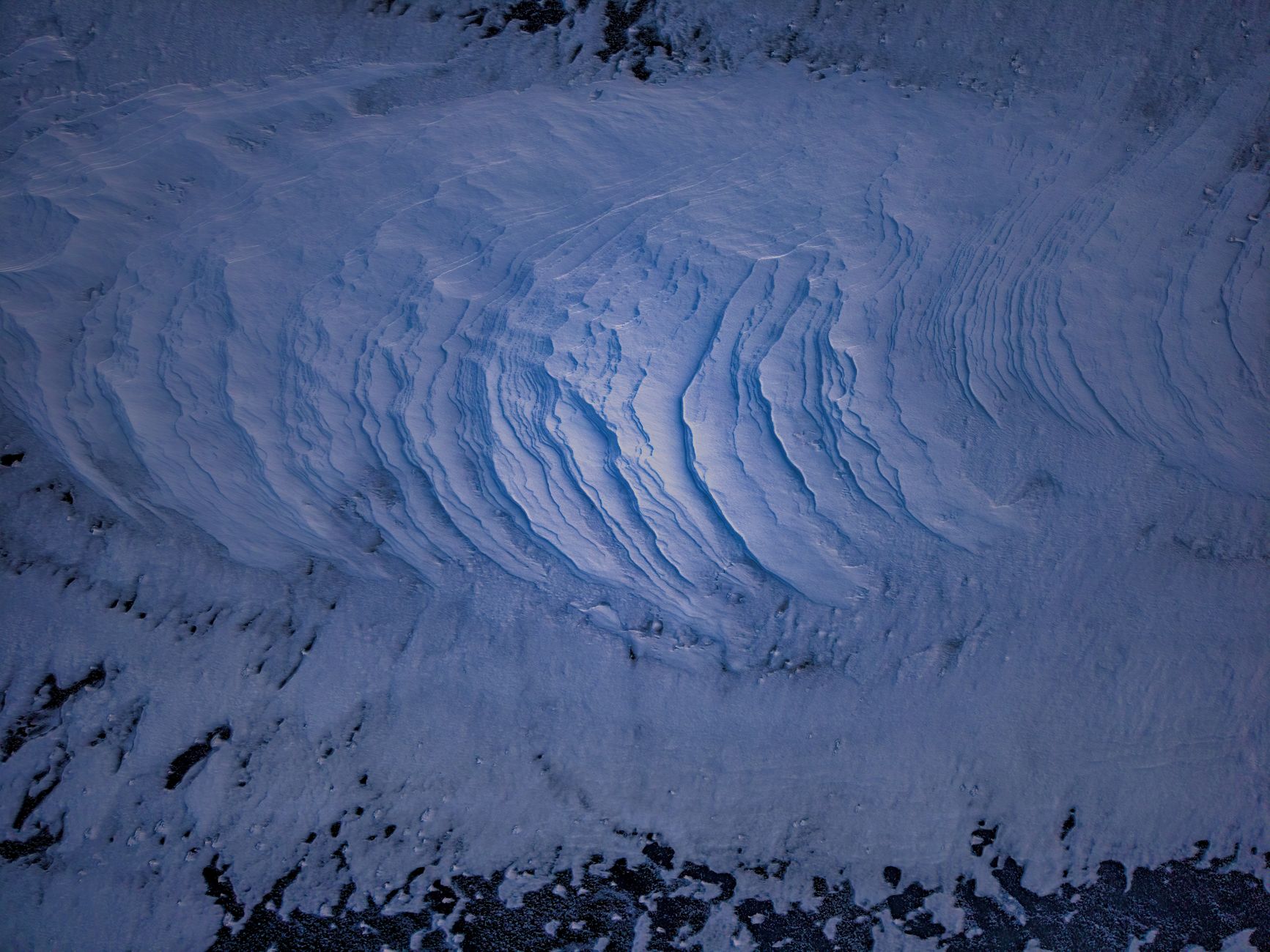A stunning aerial view showcasing intricate ice patterns on a frozen lake in Lake City, Minnesota.