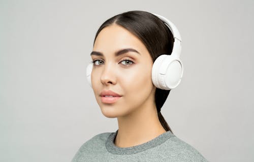 Woman in Gray Crew Neck Shirt Wearing White Headphones