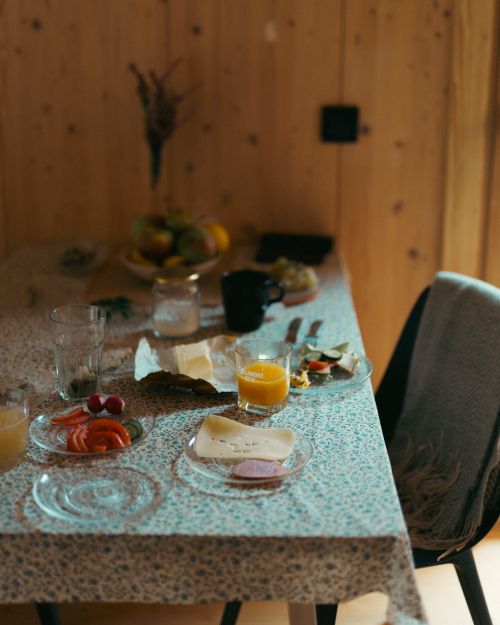 Free Inviting breakfast scene with juice and cheese on a patterned tablecloth in Podkarpackie, Poland. Stock Photo