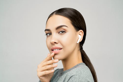 Close-Up Photo of Woman Wearing Earpods