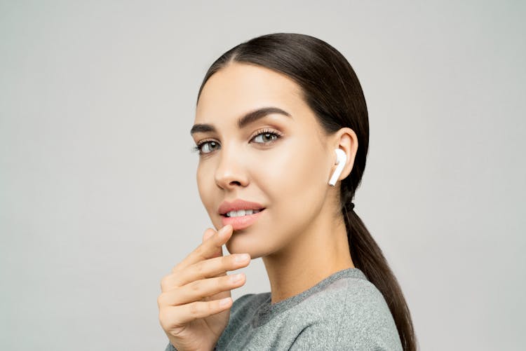 Close-Up Photo Of Woman Wearing Earpods