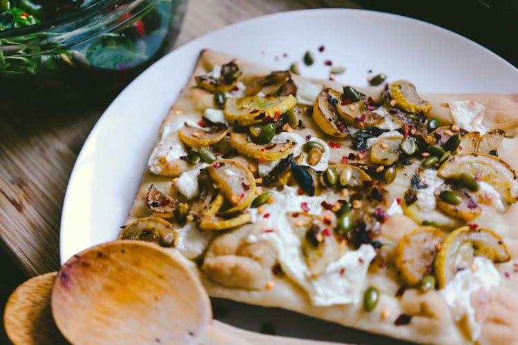 Pizza Slice On White Ceramic Plate