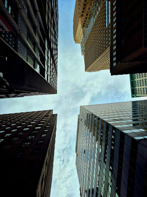 Free Impressive upward view of New York City's skyscrapers under a bright sky, showcasing urban architecture. Stock Photo