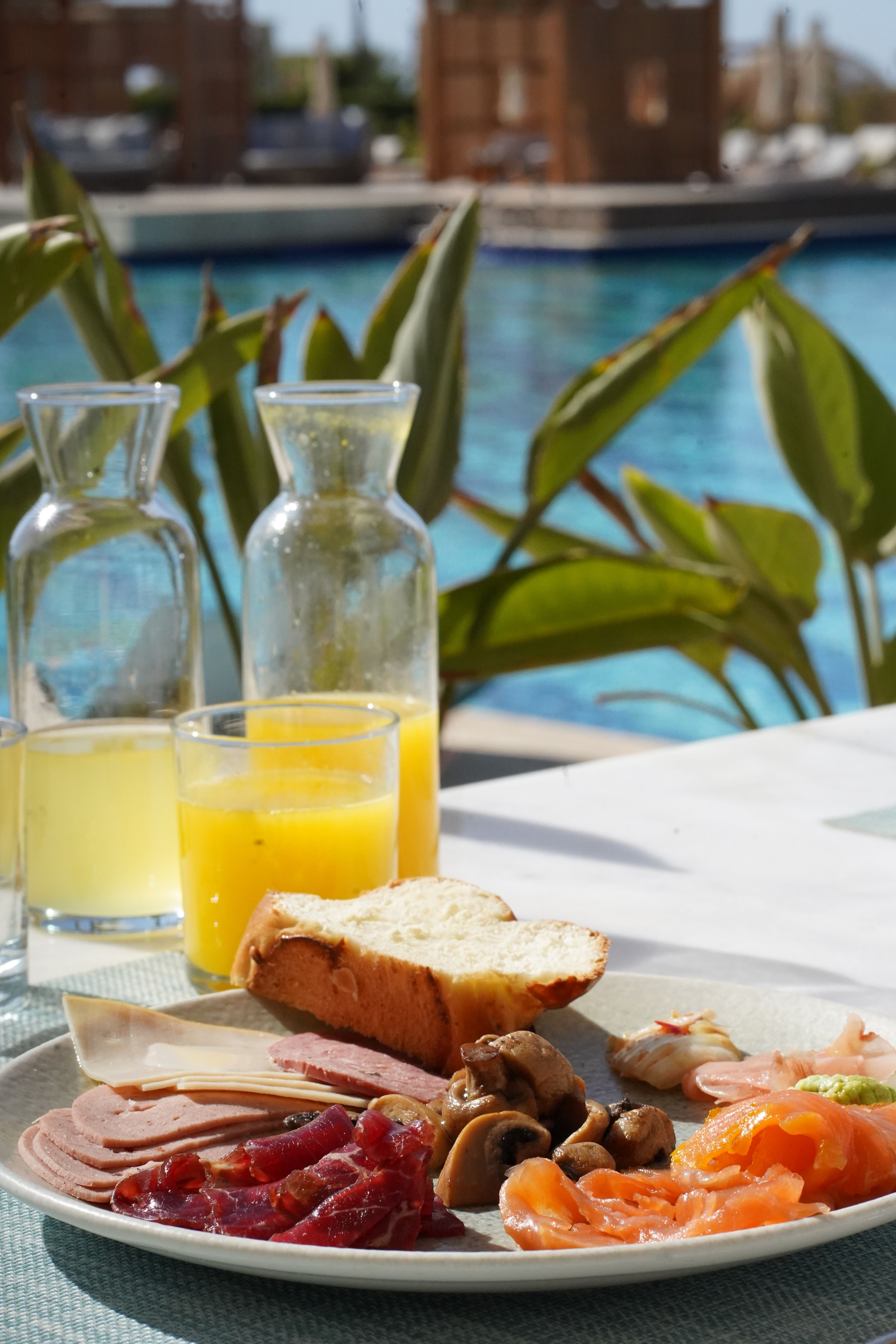 Delicious Poolside Breakfast with Orange Juice · Free Stock Photo