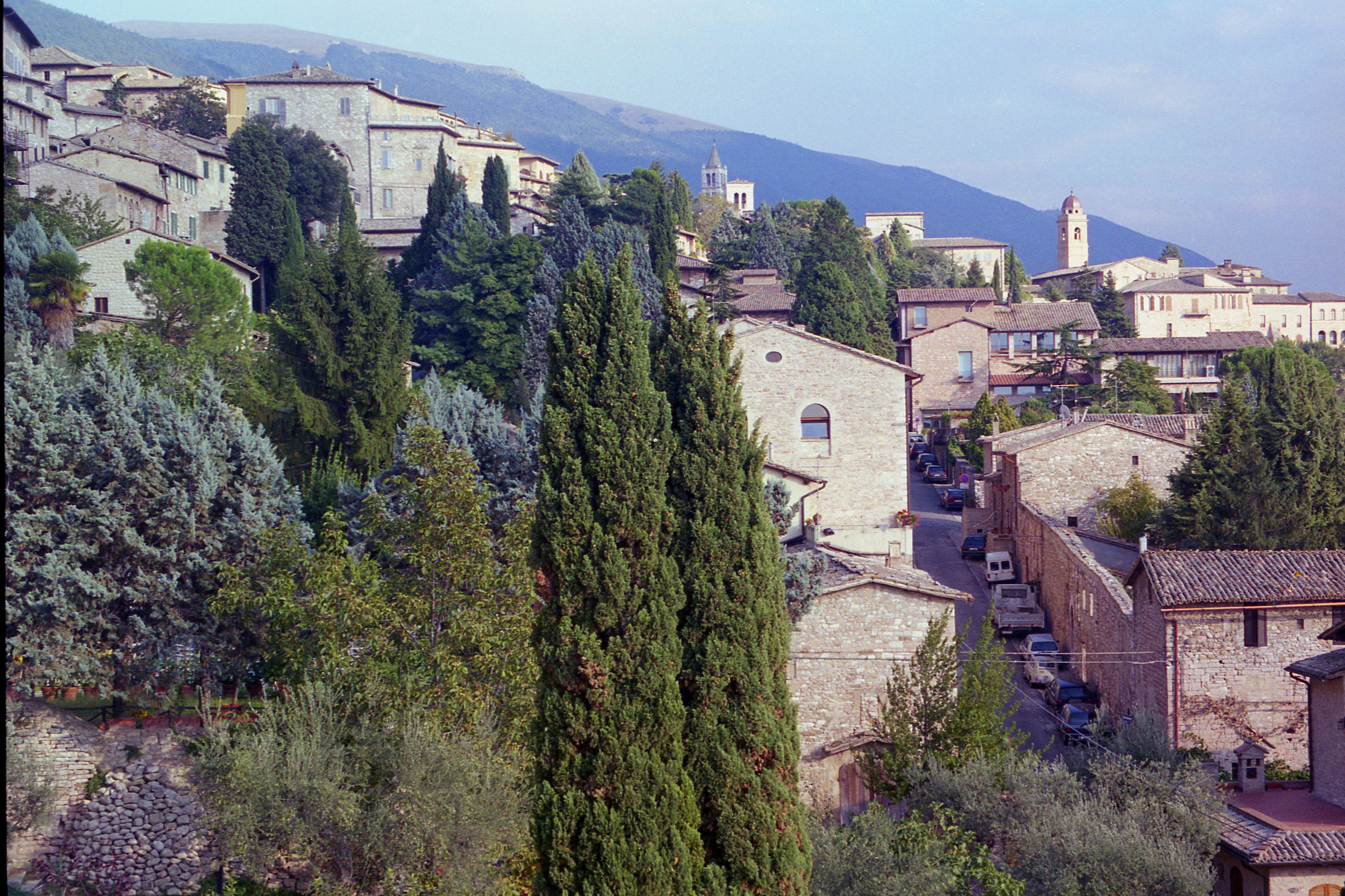 Explore the charming medieval architecture of a hillside town in Assisi, Italy.