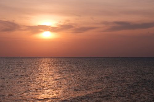 Free Serene sunset over the sea in Phu Quoc, Vietnam, with warm hues and calming waves. Stock Photo