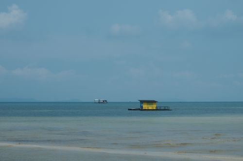 Free A serene view of a yellow floating house on the tranquil Phu Quoc beach in Vietnam. Stock Photo