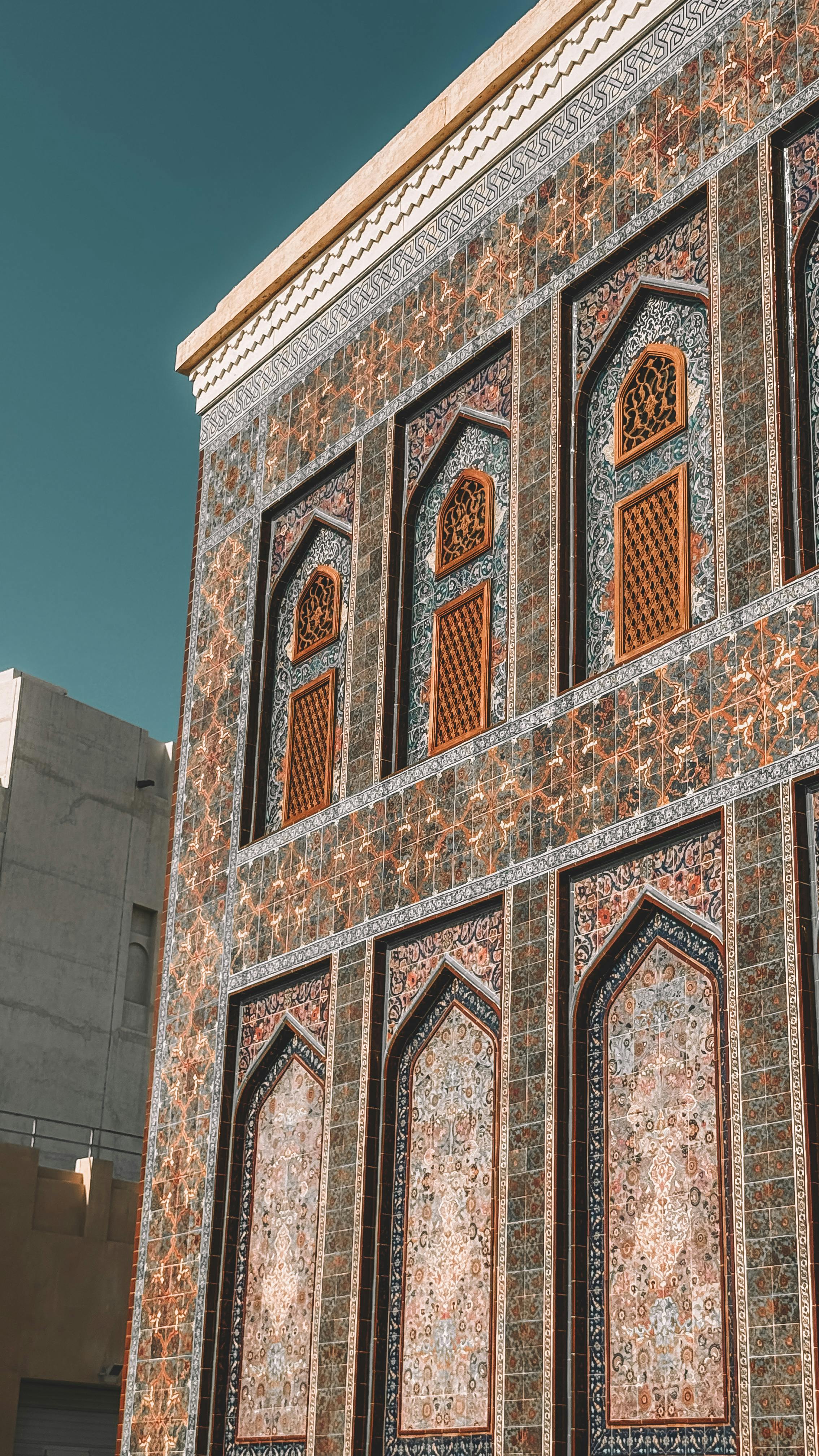 Stunning facade of a traditional Middle Eastern building with intricate tilework in Dubai.