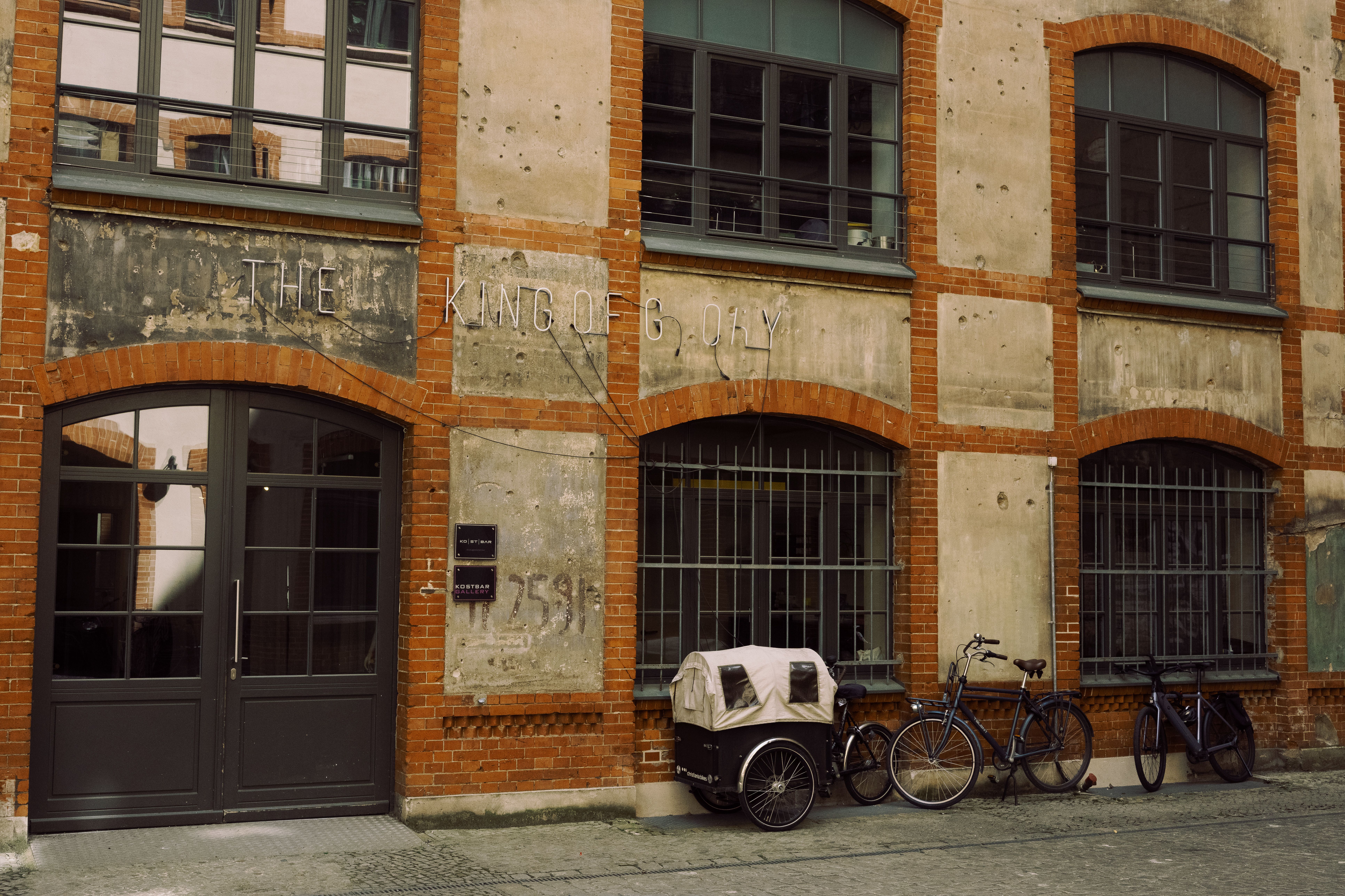 Charming historic brick building facade with bicycles parked in Berlin, Germany. Urban architectural scene.