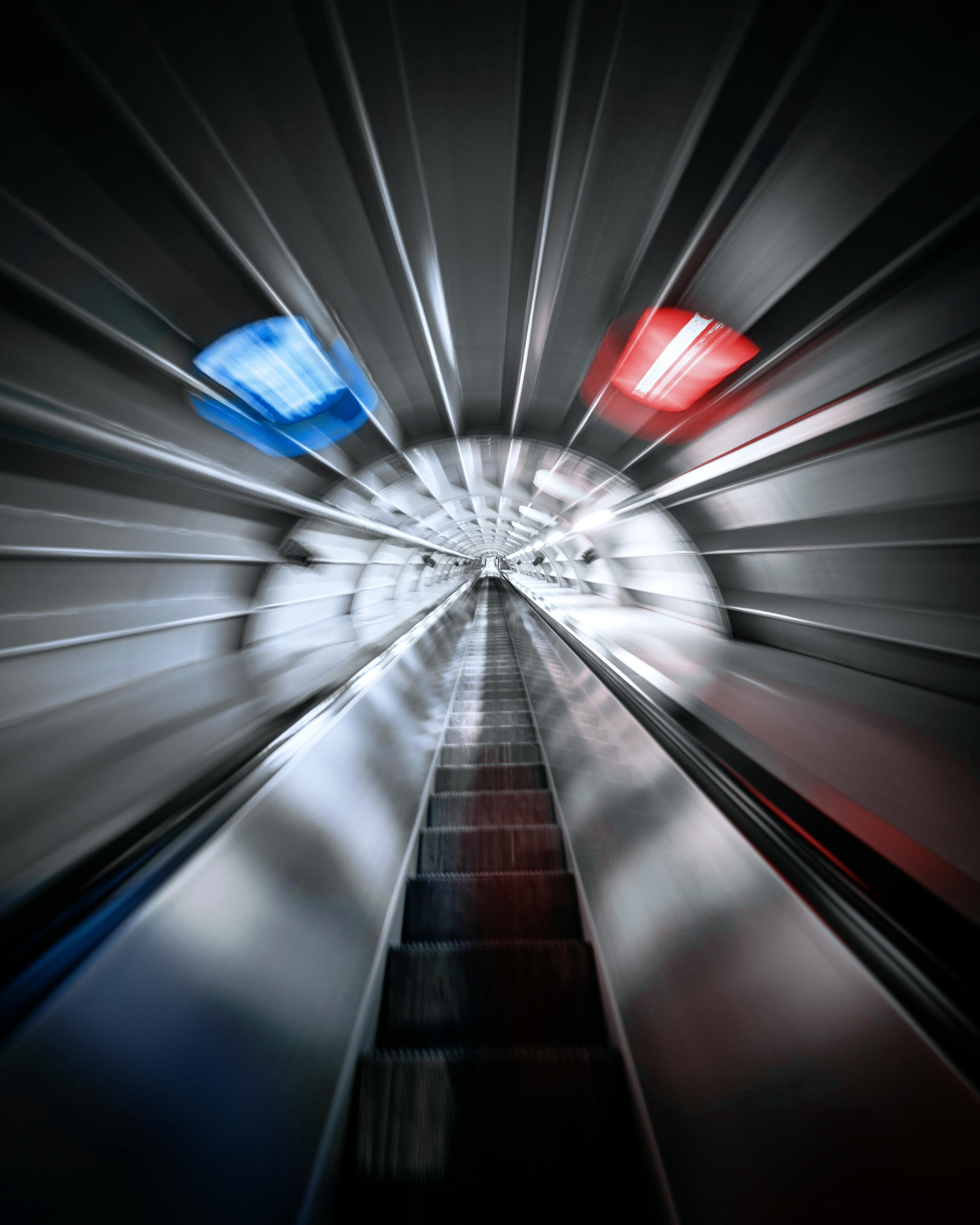 futuristic view of escalator in gray tunnel