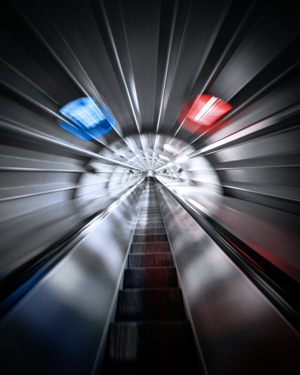 Futuristic view of escalator in gray tunnel