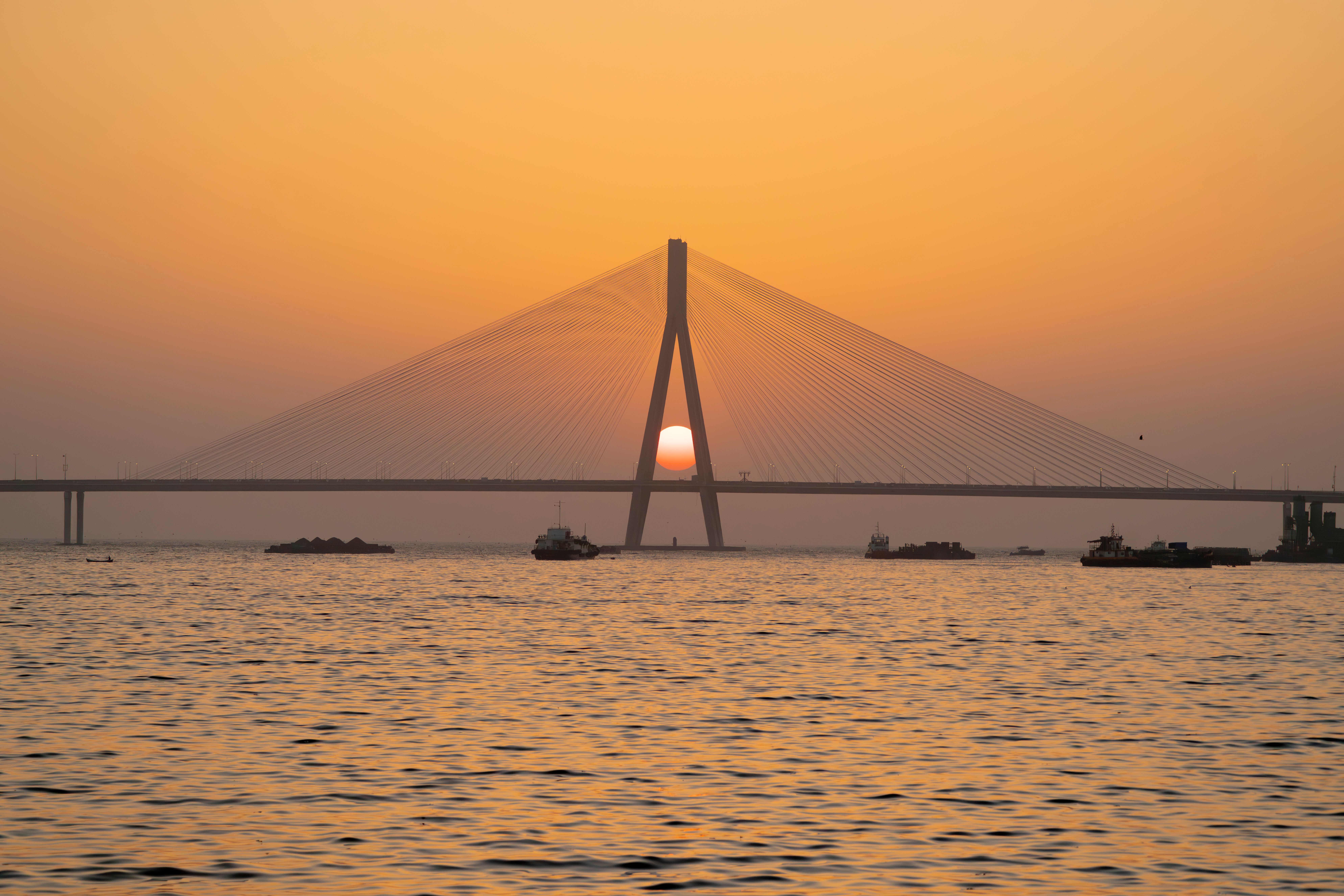 A white domed dargah reached by a stone causeway across Mumbai's Worli bay