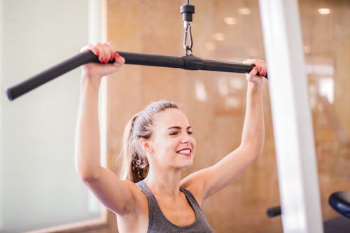 Photo Of Woman Using Gym Equipment
