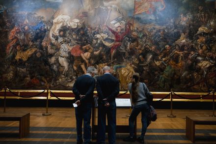 Visitors studying a vast history painting in a gallery — Krystian Baran on Pexels
