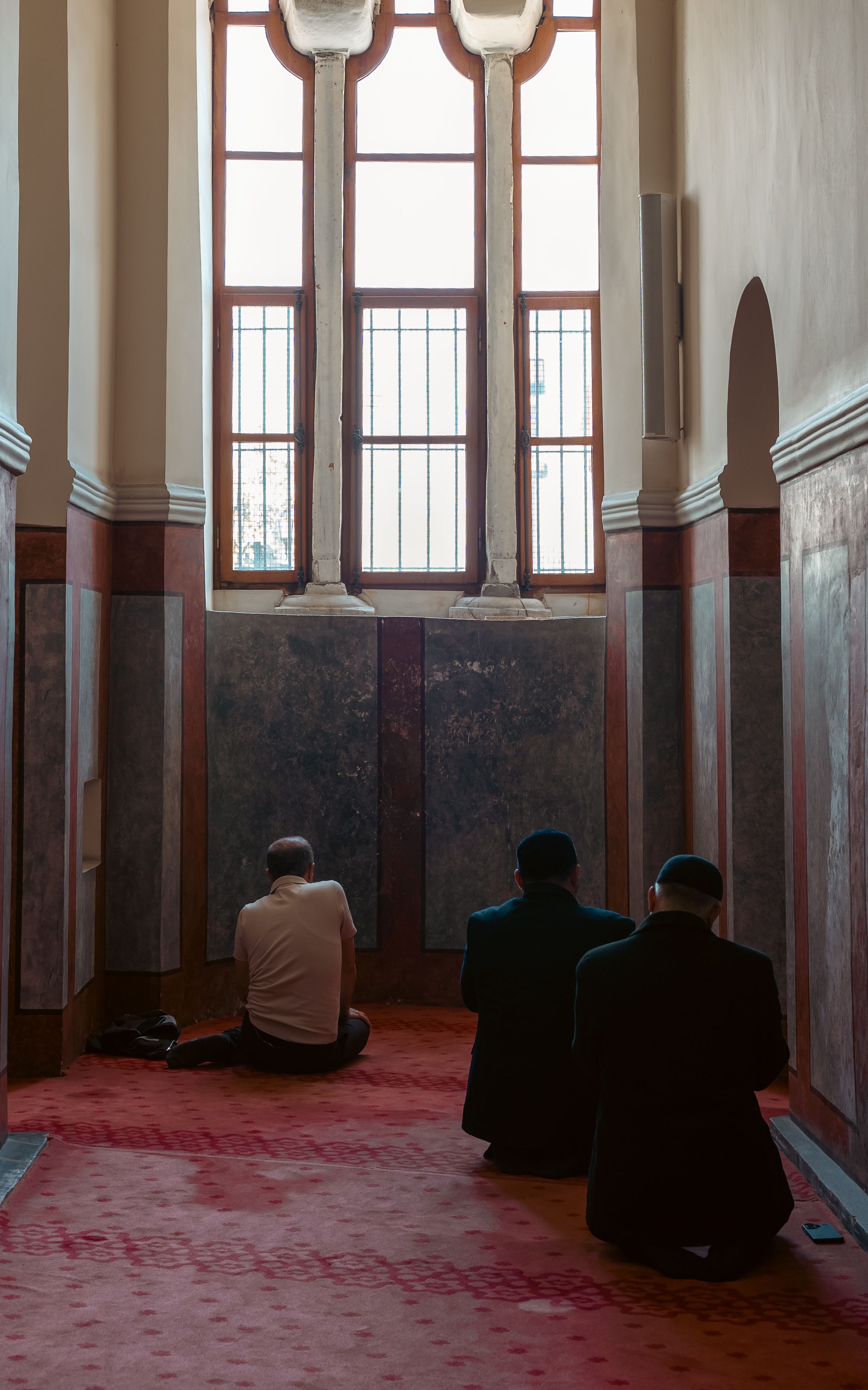 Men Praying in a Mosque Corridor · Free Stock Photo