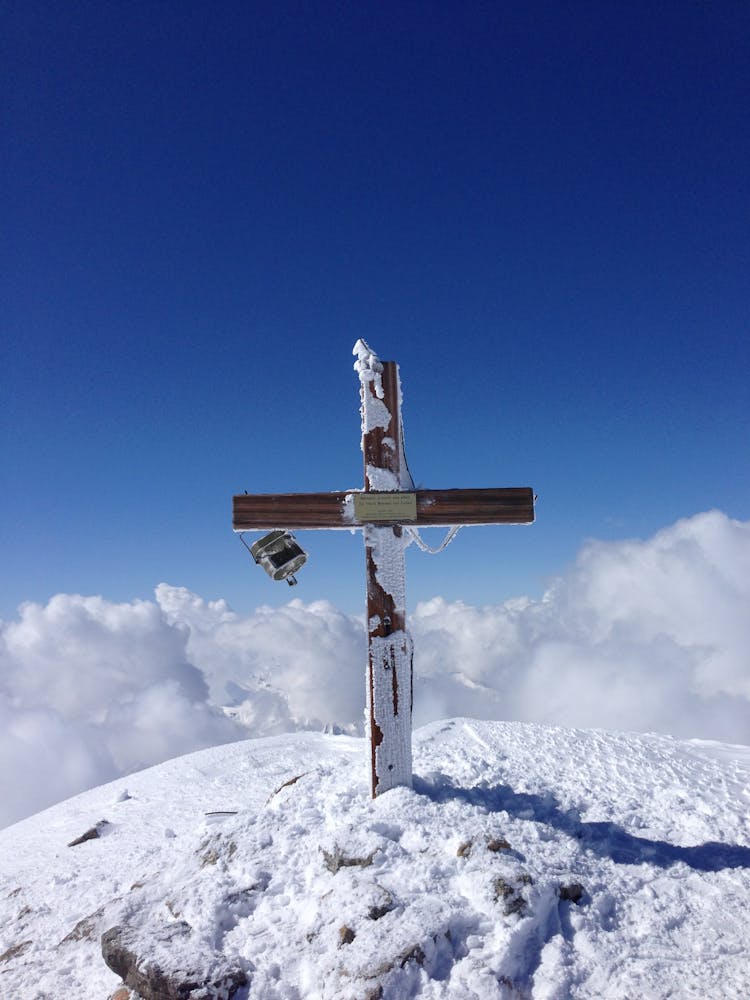 Grave Cross On Snowy Hilltop