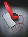 Space Gray Iphone 6 and Red On-ear Headphones