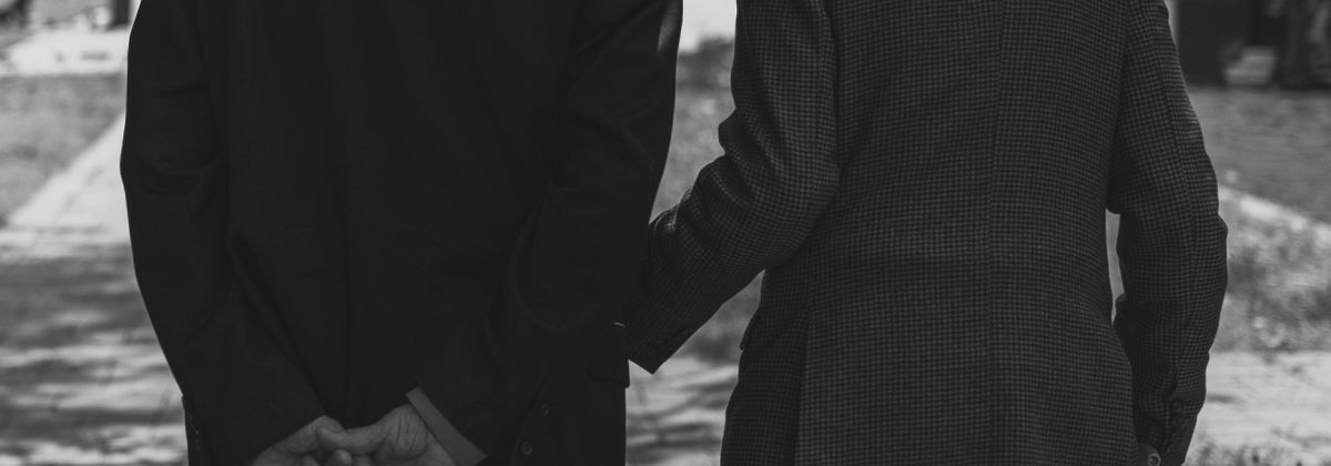Two older adults walking together