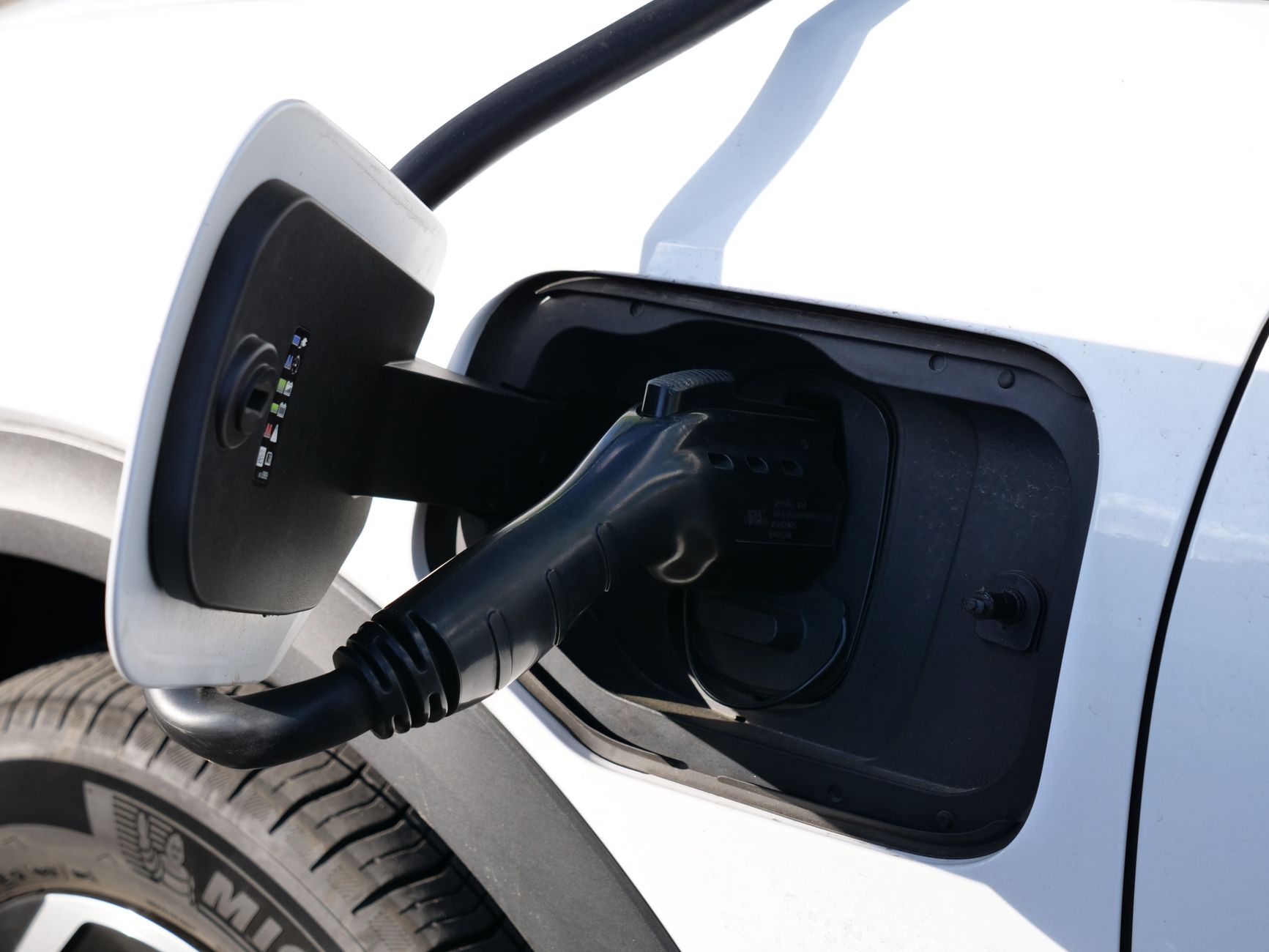 EV charger cable stored in car trunk